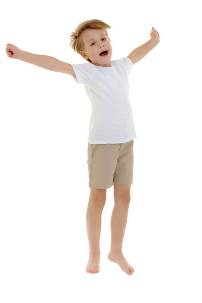 A little boy in a clean white T-shirt is jumping fun. - Foto, Bild