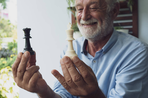 hombre mayor felicidad pensando y jugando ajedrez en balcón cerca
  - Foto, Imagen