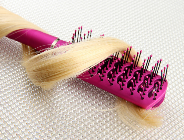 Comb brush with hair, on grey background - 写真・画像