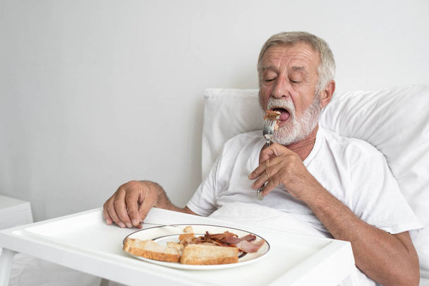 senior man with smiling nurse, takes care breakfast and discussi - Foto, Imagen