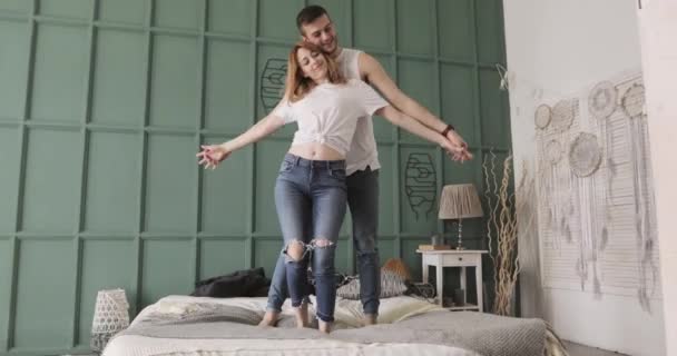 Young romantic couple dancing and hugging standing in bed. Relationship and love concept. - Πλάνα, βίντεο