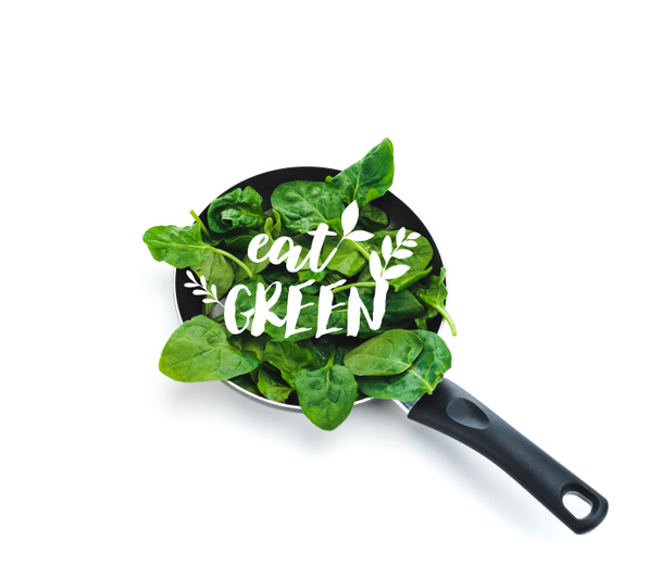 foglie di spinaci freschi in padella con scritte verdi su fondo bianco
 - Foto, immagini