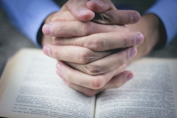 praying hands over a holy bible - Photo, Image