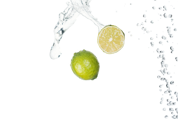 green fresh limes with clear water splash isolated on white - Photo, Image