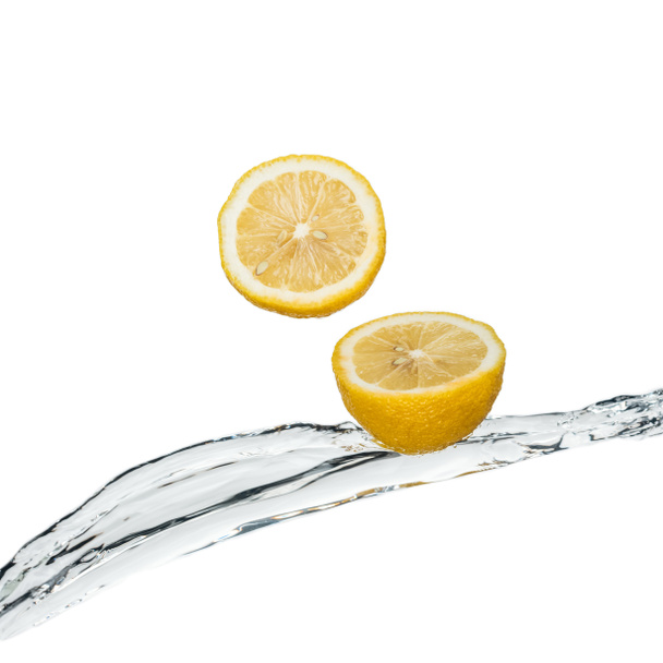 yellow fresh lemons with clear water stream isolated on white - Foto, Imagem