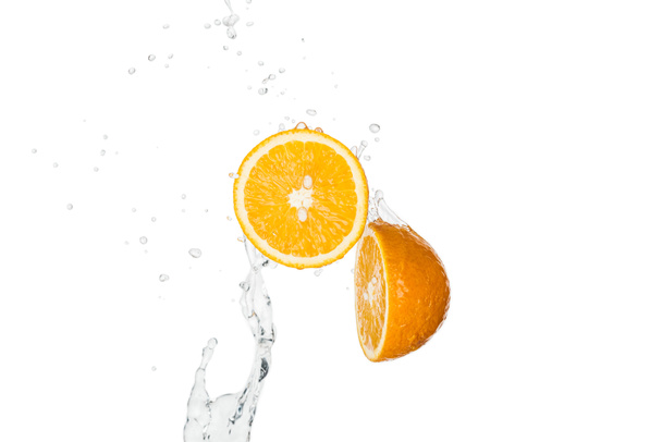 fresh orange halves with water splash and drops isolated on white - Foto, afbeelding