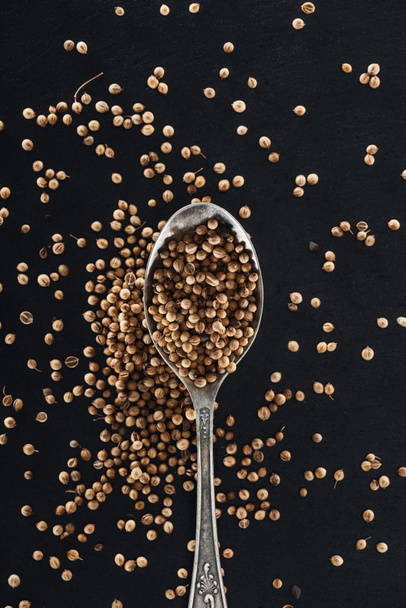 top view of Coriander in silver spoon on black background - Photo, Image