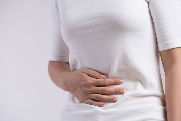 Young woman having painful stomachache. Chronic gastritis. Abdomen bloating and healthcare concept. - Fotó, kép