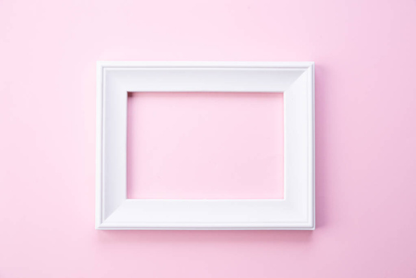 Happy Mothers day concept. Top view of white picture frame on pink pastel background. Flat lay. - Zdjęcie, obraz