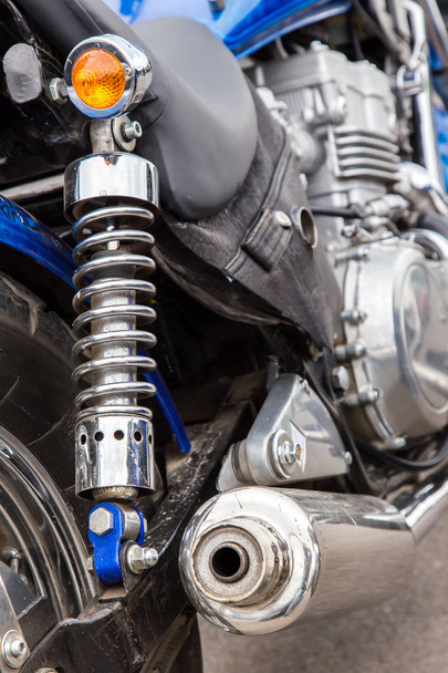 Parts of a racing motorcycle. Wheel, shock absorber and exhaust pipe close-up. - Foto, Imagen