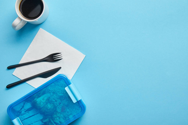 Вид сверху коробки с обедом и чашкой кофе на синем фоне
 - Фото, изображение