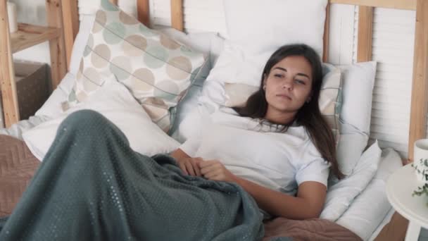 Girl wakes up in morning, pulls her hands, smiles, slow motion - Filmati, video