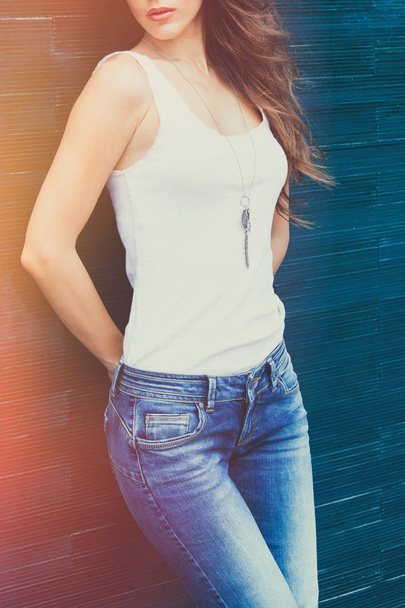 girl in white tank shirt and blue jeans outdoor summer day lean  - Фото, изображение