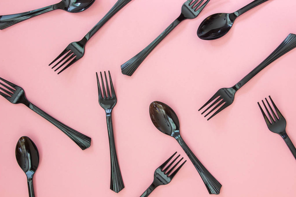Forks and spoons on a pink background. Minimal concept. - Фото, зображення