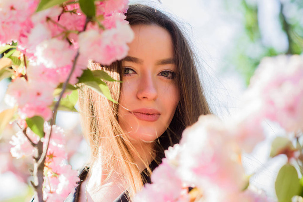 blossom smell, allergy. woman in spring flower bloom. skincare and spa. Natural cosmetics for skin. girl in cherry flower. Sakura tree blooming. natural summer beauty. Spring mood - Foto, Imagem