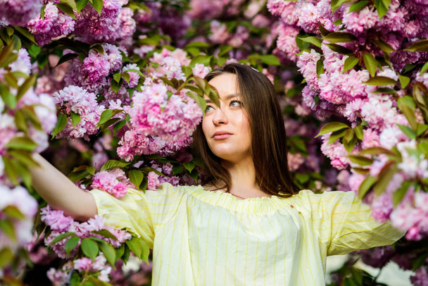 Spring holidays. natural summer beauty. girl in cherry flower. Sakura tree blooming. blossom smell, allergy. skincare and spa. Natural cosmetics for skin. woman in spring flower bloom - Φωτογραφία, εικόνα