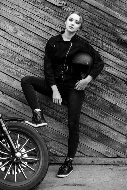 Attractive stylish  girl posing with motorcycle, black and white photo - Foto, imagen