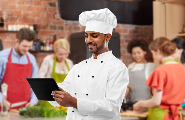 male indian chef with tablet pc at cooking class - Photo, image
