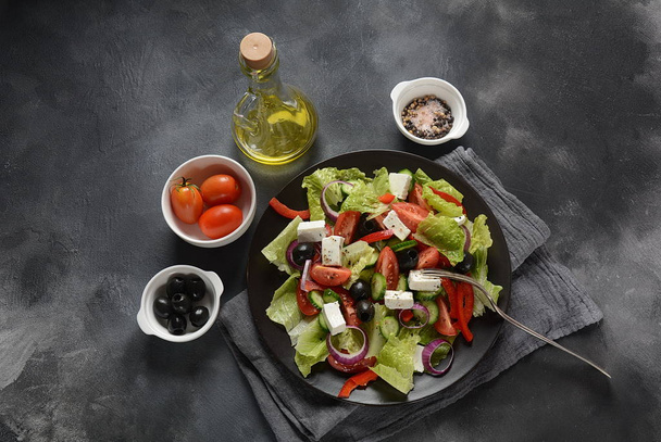 Insalata greca con cetriolo fresco, pomodorini, peperone dolce, lattuga, cipolla rossa, olive e olio d'oliva e formaggio feta. Concetto di cibo sano
  - Foto, immagini