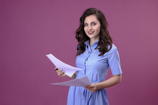 Attractive smiling business woman with documents in her hands. - Φωτογραφία, εικόνα