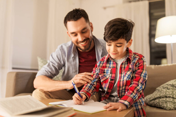 father and son doing homework together - Photo, image