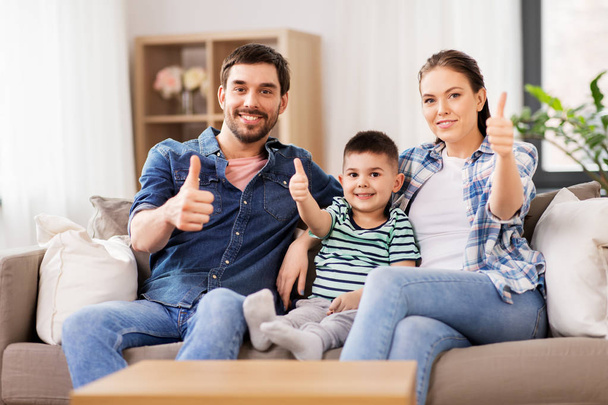 portrait of happy family showing thumbs up at home - Фото, изображение