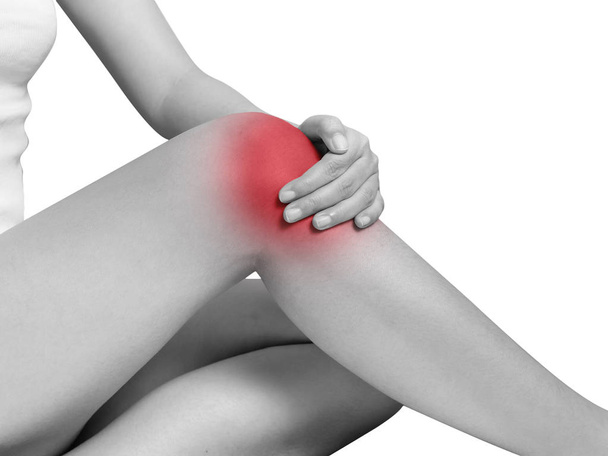 woman suffering from knee pain, joint pains. mono tone highlight at knee isolated on white background. health care and medical concept - Foto, immagini