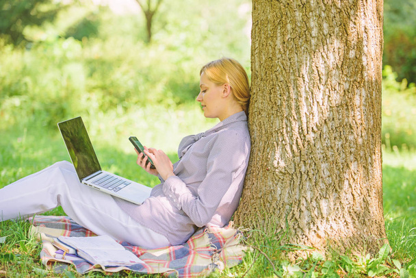 Modern technology give more opportunities to realize your potential. Use opportunity digital technology. Woman with laptop and smartphone working outdoors. Girl use modern technology for business - Fotoğraf, Görsel