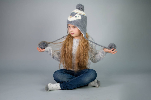 Piękna uśmiechnięta Nastoletnia dziewczyna z długimi włosami w zimowym kapeluszu-na szarym-srebrnym tle - Zdjęcie, obraz