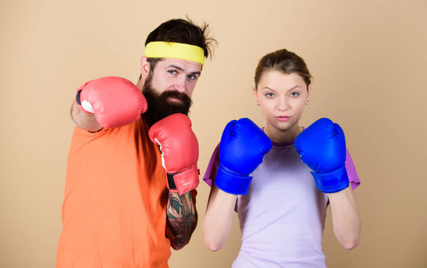 training with coach. sportswear. Fight. knockout and energy. couple training in boxing gloves. punching, sport Success. Happy woman and bearded man workout in gym. Hustle, hit and never quit - 写真・画像