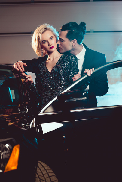 stylish man kissing beautiful sensual woman near car - Photo, image
