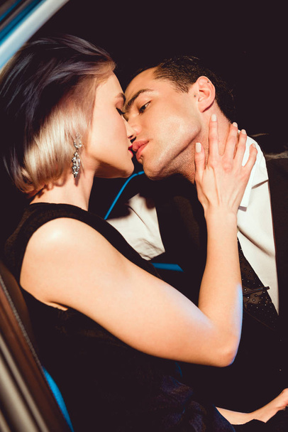 beautiful fashionable young woman kissing handsome man  - Fotoğraf, Görsel