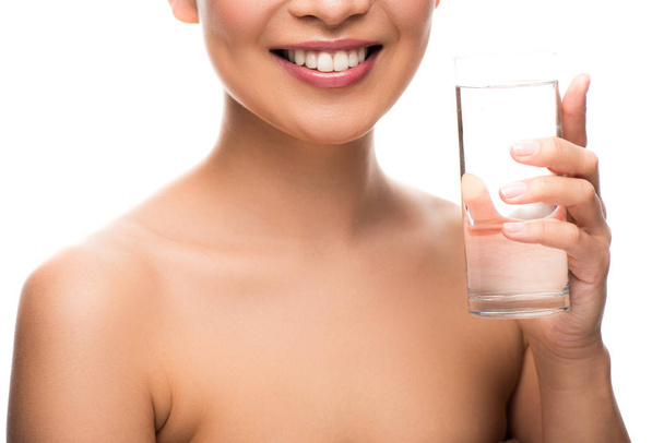cropped view of smiling woman with glass of water, isolated on white - Photo, Image