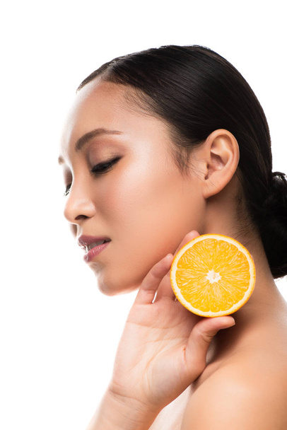 beautiful asian girl holding orange, isolated on white - 写真・画像