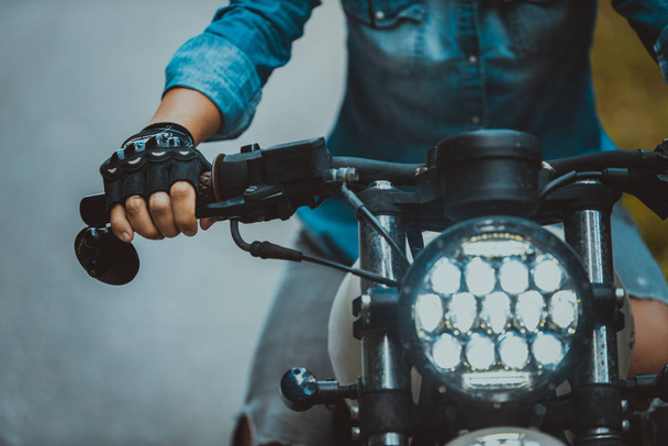 Nainen moottoripyöräilijä ajaa kahvila 'racer moottoripyörä
 - Valokuva, kuva
