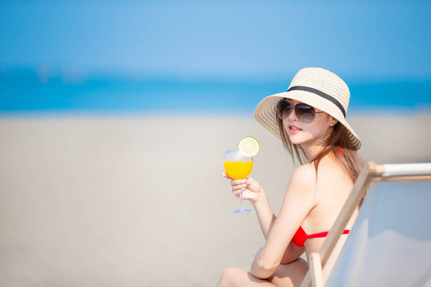 woman sunbathing with juice - Photo, Image