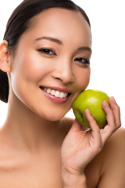 beautiful smiling asian woman holding green apple, isolated on white - 写真・画像
