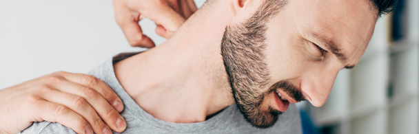 panoramic shot of chiropractor massaging neck of man  - Foto, Imagem