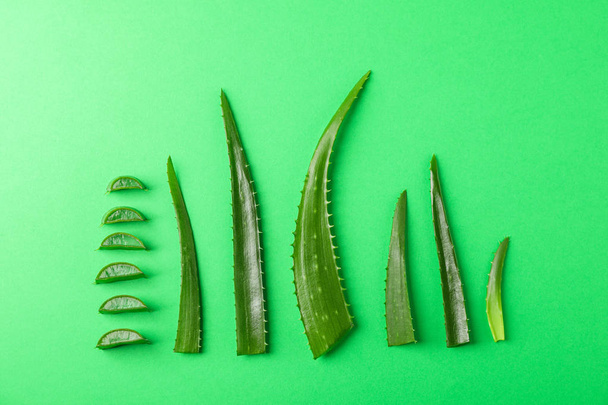 Aloe vera leaves and slices on color background, space for text. - Foto, Bild