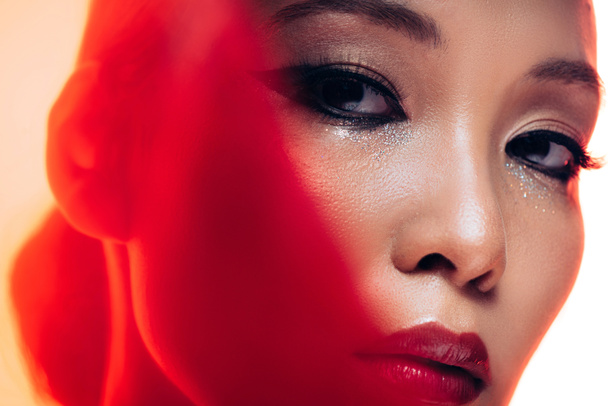 perfect asian woman with makeup in red light  - 写真・画像