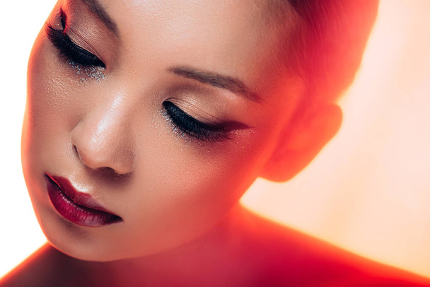 beautiful asian woman in red light, toned picture - Photo, Image