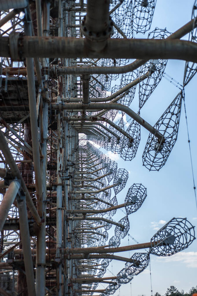 Telecommunication radio center in Pripyat, Chernobyl area known as "the Arc" or "Duga" and so called "Russian woodpecker" with  blue sky on background - Fotó, kép