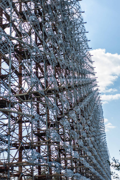 Telecommunication radio center in Pripyat, Chernobyl area known as "the Arc" or "Duga" and so called "Russian woodpecker" with  blue sky and clouds on background - Zdjęcie, obraz