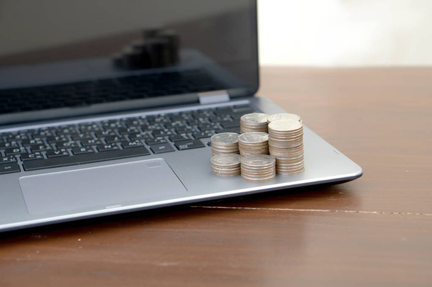 Stack coins on laptop. Financial, - Foto, afbeelding