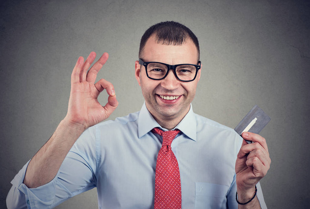 Cheerful happy business man with credit card showing Ok sign  - Foto, immagini