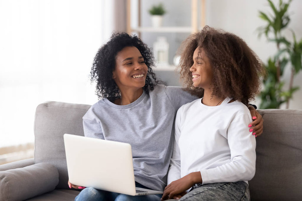 African American mother and daughter using laptop, having fun together - Fotoğraf, Görsel