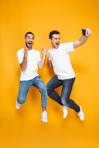 Full length of two cheerful excited men friends - Fotoğraf, Görsel