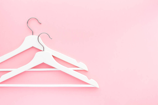 White hangers on pastel pink background - Photo, Image