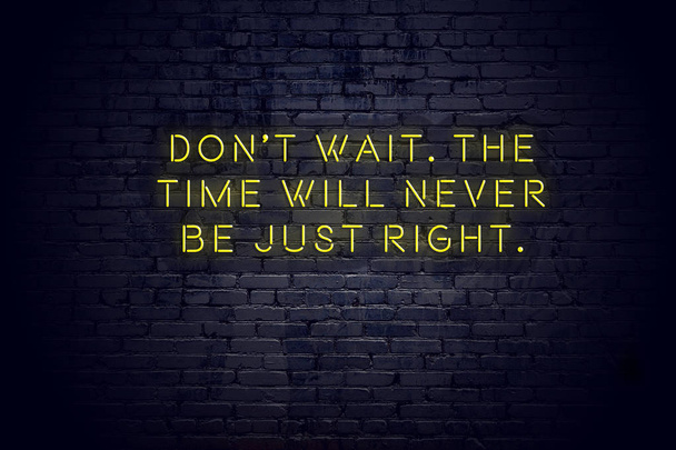 Neon sign with positive wise motivational quote against brick wall  - Photo, Image