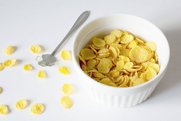 Healthy breakfast with cornflakes and milk over white background - Photo, Image